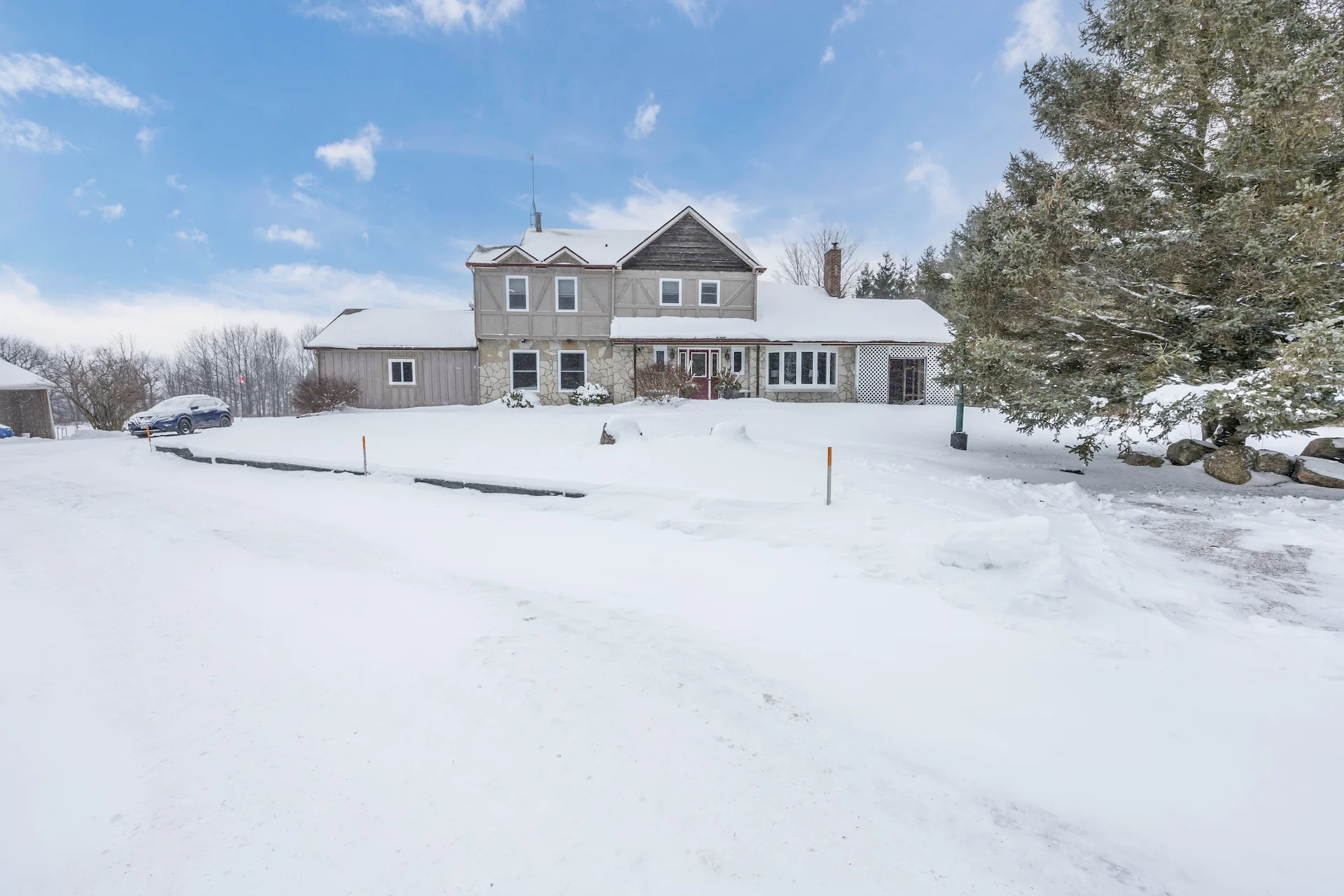 Front of a large house covered in snow